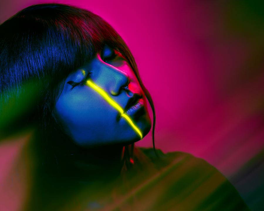 Sleepwire: A sleeping profile in blue, one yellow neon line running down the face, on magenta