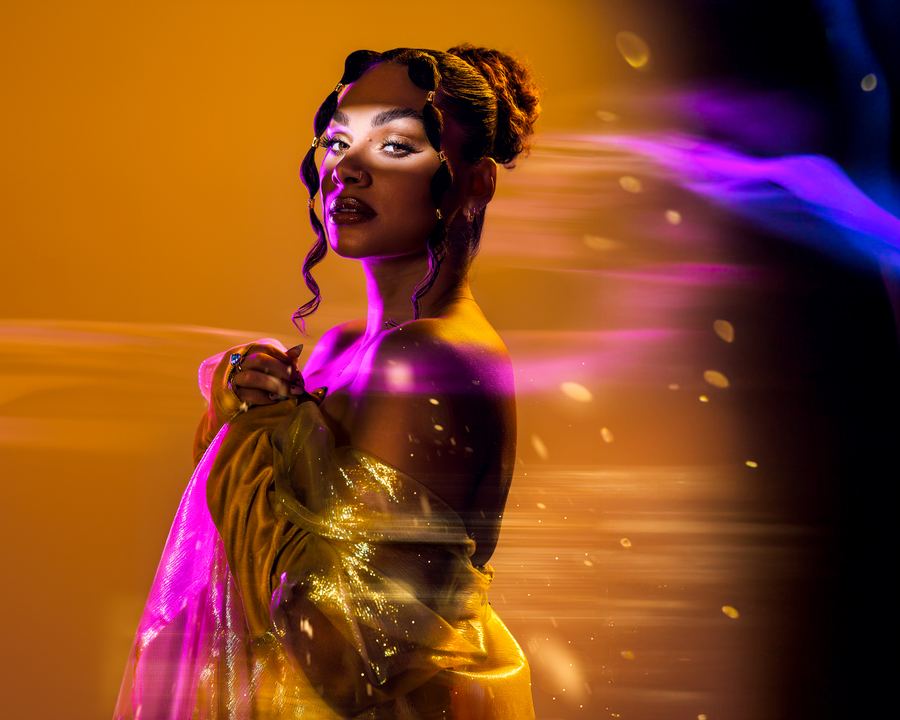 Goldrush: Gold fabric and pinned curls caught mid-turn, trailed by streaks of violet light