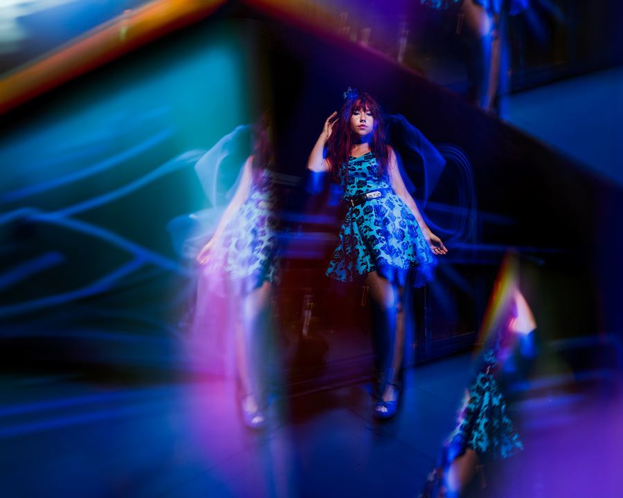 Déjà Vu: A blue floral dress repeated through a room of long-exposure light trails