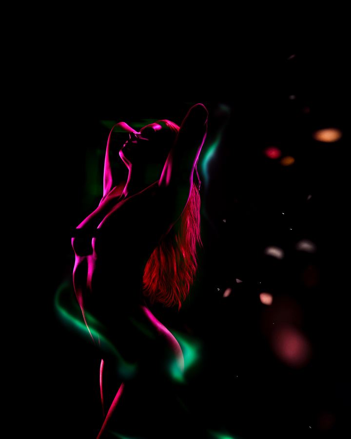 Northern Lights: A body drawn only by its magenta and green rim light, on black