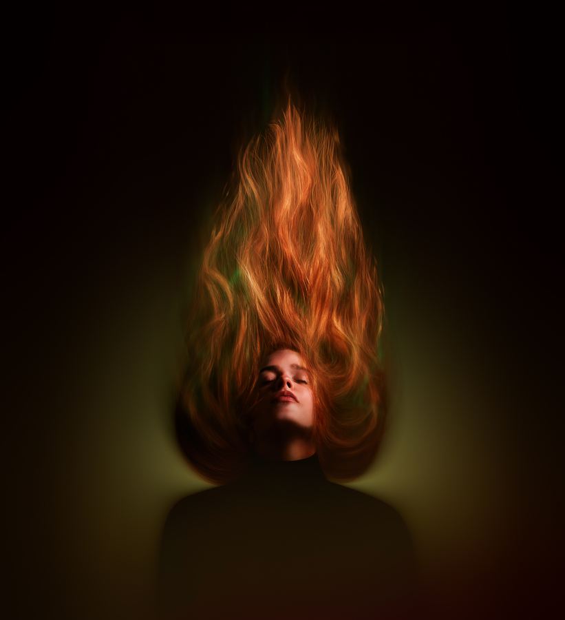 Matchstick: Hair lifted straight up into a flame above a still face