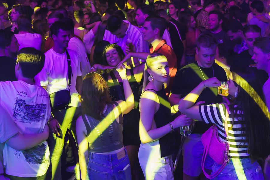 A dance floor striped with yellow light beams