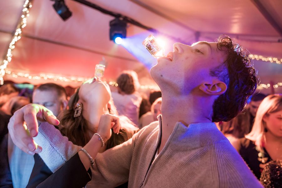 A shot poured straight from the bottle, lit by a blue spotlight