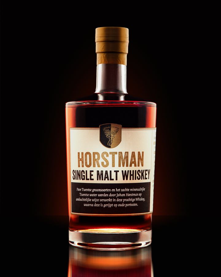 Horstman single malt whiskey, backlit amber on black