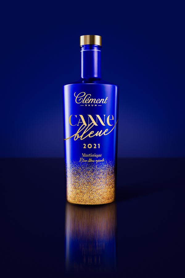 Clément Canne Bleue 2021 rum, gold flecks rising from the base, on blue