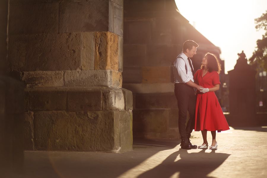 Dancing beside an old sandstone wall in low sun