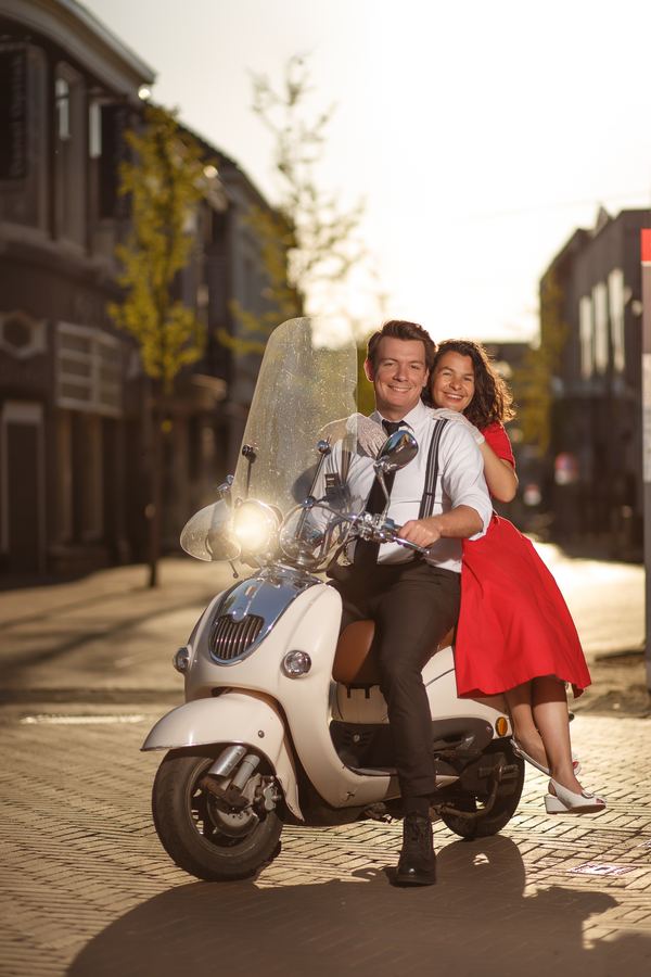 Both laughing on the Vespa in the old town